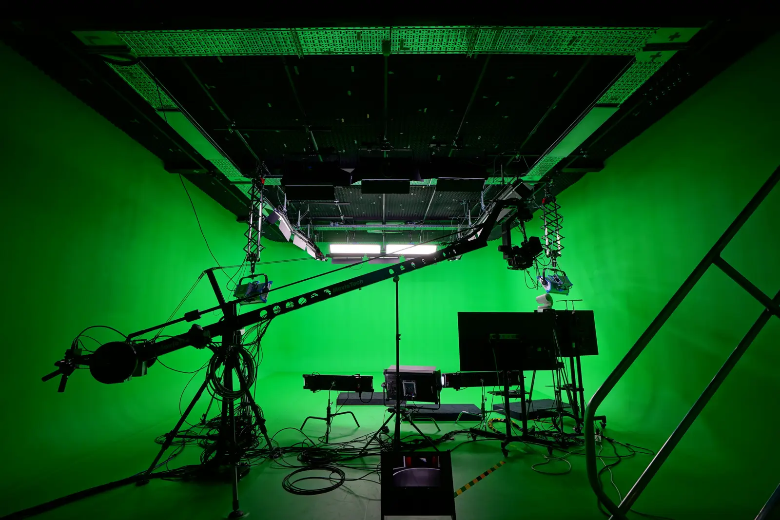 A professional green-screen studio with lighting rigs