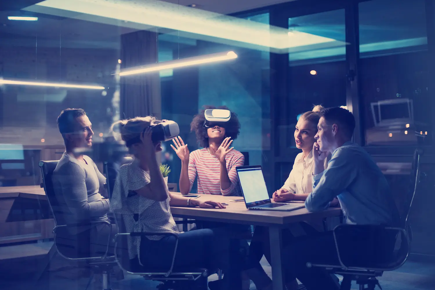 A team wearing virtual-reality headsets in a dark office